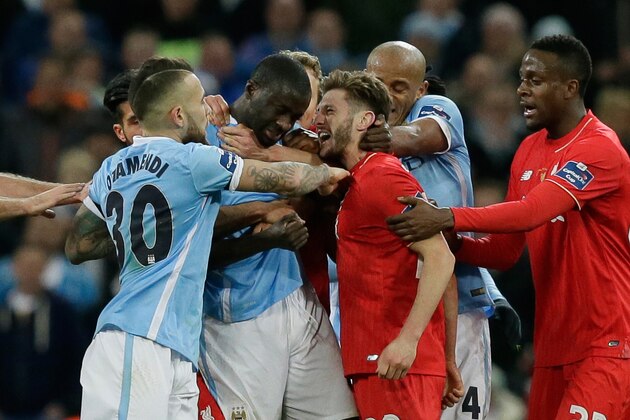 Manchester City's Yaya Toure, center left, and Liverpool's Adam Lallana, center right, clash during the English League Cup final soccer match between Liverpool and Manchester City at Wembley stadium in London, Sunday, Feb. 28, 2016. (AP Photo/Tim Ireland)