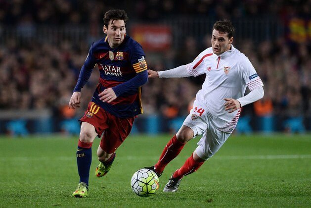 Barcelona's Argentinian forward Lionel Messi (L) vies with Sevilla's Uruguayan midfielder Sebastian Cristoforo during the Spanish league football match FC Barcelona vs Sevilla FC at the Camp Nou stadium in Barcelona on February 28, 2016. / AFP / JOSEP LAGO        (Photo credit should read JOSEP LAGO/AFP/Getty Images)