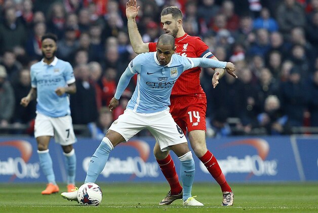 Manchester City's Fernando, left, and Liverpool’s Jordan Henderson challenge for the ball during the English League Cup final soccer match between Liverpool and Manchester City at Wembley stadium in London, Sunday, Feb. 28, 2016.(AP Photo/Kirsty Wigglesworth)