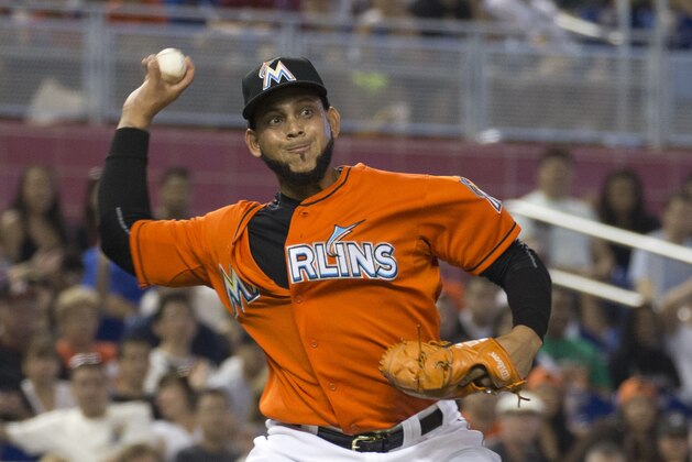 Miami Marlins starting pitcher Henderson Alvarez tries to make a play at first base after being hit by and then dropping the ball during the second inning of a baseball game against the Atlanta Braves in Miami, Sunday, May 17, 2015. (AP Photo/J Pat Carter)