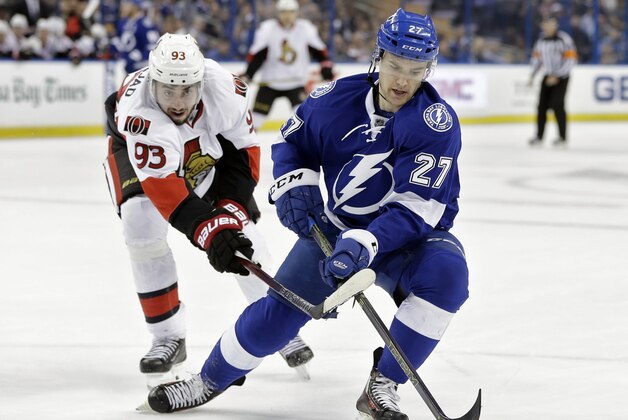 Tampa Bay Lightning left wing Jonathan Drouin (27) loses the puck to a stick-check by Ottawa Senators center Mika Zibanejad (93), of Sweden, during the first period of an NHL hockey game Thursday, Dec. 10, 2015, in Tampa, Fla. (AP Photo/Chris O'Meara)