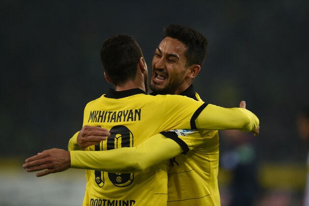 Dortmund's Armenian midfielder Henrikh Mkhitaryan (L) and Dortmund's midfielder Ilkay Guendogan celebrate the third goal during the German first division football Bundesliga match Borussia Moenchengladbach vs Borussia Dortmund in Moenchengladbach, western Germany, on January 23, 2016. / AFP / PATRIK STOLLARZ / RESTRICTIONS: DURING MATCH TIME: DFL RULES TO LIMIT THE ONLINE USAGE TO 15 PICTURES PER MATCH AND FORBID IMAGE SEQUENCES TO SIMULATE VIDEO. == RESTRICTED TO EDITORIAL USE == FOR FURTHER QUERIES PLEASE CONTACT DFL DIRECTLY AT + 49 69 650050
        (Photo credit should read PATRIK STOLLARZ/AFP/Getty Images)