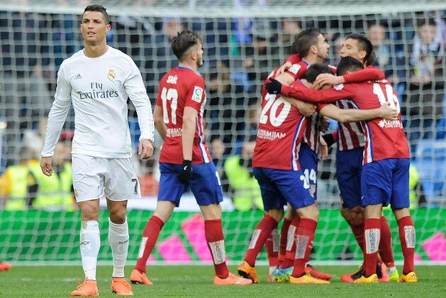 MADRID, SPAIN - FEBRUARY 27:  Cristiano Ronaldo of Real Madrid walks away from celebrating Atletico Madrid players after Atletico beat Real 1-0 in the La Liga match between Real Madrid CF and Club Atletico de Madrid at Estadio Santiago Bernabeu on February 27, 2016 in Madrid, Spain.  (Photo by Denis Doyle/Getty Images)