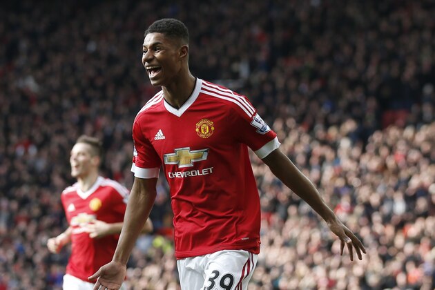Manchester United's Marcus Rashford, runs to celebrate with teammates after scoring his sides second goal of the game during the English Premier League soccer match between Manchester United and Arsenal at Old Trafford Stadium, Manchester, England, Sunday, Feb. 28, 2016. (AP Photo/Jon Super)