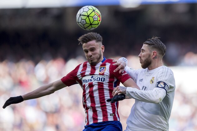 MADRID, SPAIN - FEBRUARY 27: Saul Niguez of Atletico de Madrid wins the header before Sergio Ramos of Real Madrid CF during the La Liga match between Real Madrid CF and Club Atletico de Madrid at Estadio Santiago Bernabeu on February 27, 2016 in Madrid, Spain.  (Photo by Gonzalo Arroyo Moreno/Getty Images)