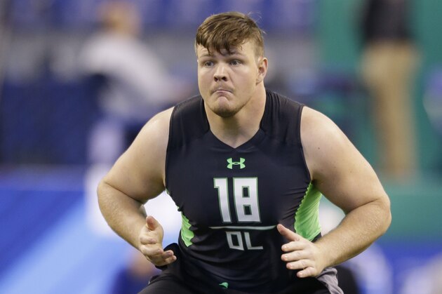 Michigan offensive lineman Graham Glasgow runs a drill at the NFL football scouting combine in Indianapolis, Friday, Feb. 26, 2016. (AP Photo/Michael Conroy)