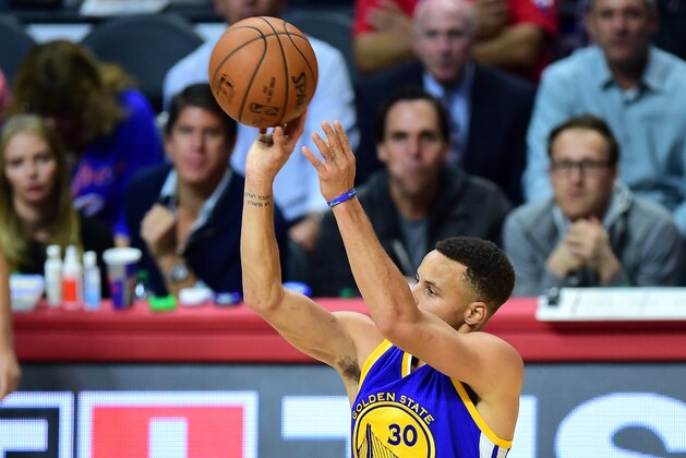 Steph Curry of the Golden State Warriors shoots for three against the Los Angeles Clippers during their NBA game in Los Angeles, California on November 19, 2015 where the Warriors defeated the Clippers 124-117. AFP PHOTO / FREDERIC J. BROWN        (Photo credit should read FREDERIC J. BROWN/AFP/Getty Images)