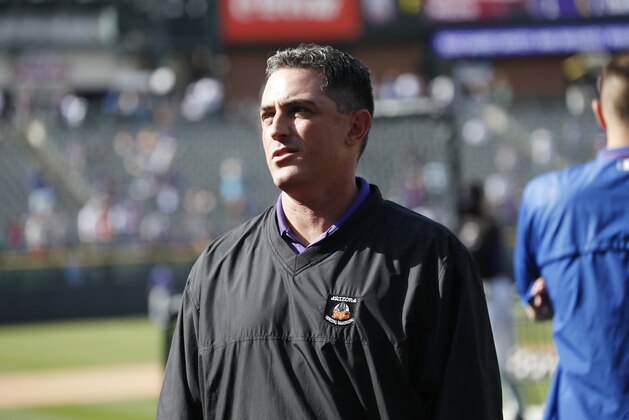 Colorado Rockies general manager Jeff Bridich looks on during batting practice before facing the Chicago Cubs in the first inning of a baseball game Saturday, April 11, 2015, in Denver. (AP Photo/David Zalubowski)