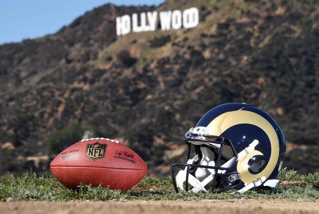 Feb 16, 2016; Los Angeles, CA, USA; General view of Los Angeles Rams helmet and NFL Wilson Duke football at Griffith Park with the Hollywood sign as a backdrop. NFL owners voted 30-2 to allow owner Stan Kroenke (not pictured) to move the St. Louis Rams to Los Angeles for the 2016 season. Mandatory Credit: Kirby Lee-USA TODAY Sports