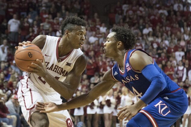 NORMAN, OK - February 13: Devonte' Graham #4 of the Kansas Jayhawks looks to block Buddy Hield #24 of the Oklahoma Sooners during a NCAA college basketball game at the Lloyd Noble Center on February13, 2016 in Norman, Oklahoma. Kansas won 76-72. (Photo by J Pat Carter/Getty Images)