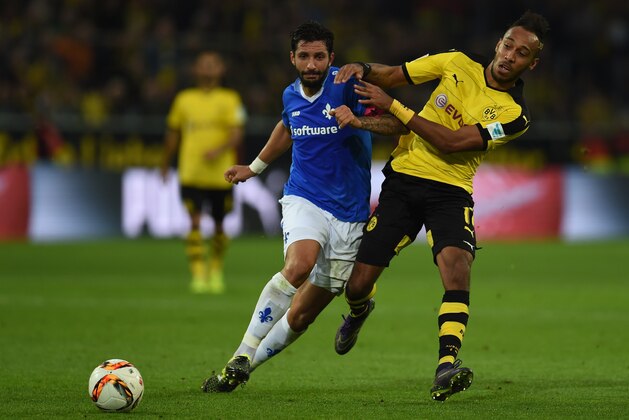 Dortmund's Gabonese striker Pierre-Emerick Aubameyang and Darmstadt's defender Aytac Sulu (L) vie for the ball during the German first division Bundesliga football match Borussia Dortmund v SV Darmstadt 98, in Dortmund, western Germany, on September 27, 2015. The match ended with a 2-2 draw. AFP PHOTO / PATRIK STOLLARZ  RESTRICTIONS: DURING MATCH TIME: DFL RULES TO LIMIT THE ONLINE USAGE TO 15 PICTURES PER MATCH AND FORBID IMAGE SEQUENCES TO SIMULATE VIDEO.  == RESTRICTED TO EDITORIAL USE == FOR FURTHER QUERIES PLEASE CONTACT DFL DIRECTLY AT + 49 69 650050.        (Photo credit should read PATRIK STOLLARZ/AFP/Getty Images)