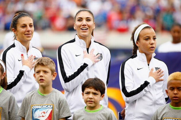 HOUSTON, TX - FEBRUARY 21:  (L-R) Carli Lloyd, #10, Hope Solo #1  and Mallory Pugh of the United States wait on the field prior to start of the game between the United States and Canada during the Championship final of the 2016 CONCACAF Women's Olympic Qualifying at BBVA Compass Stadium on February 21, 2016 in Houston, Texas.  (Photo by Scott Halleran/Getty Images)