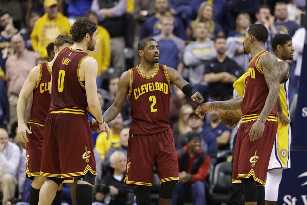 Cleveland Cavaliers guard Kyrie Irving (2) celebrates with forward Kevin Love (0) and guard J.R. Smith (5) during the second half of an NBA basketball game against the Indiana Pacers in Indianapolis, Monday, Feb. 1, 2016. The Cavaliers defeated the Pacers 111-106 in overtime. (AP Photo/Michael Conroy)