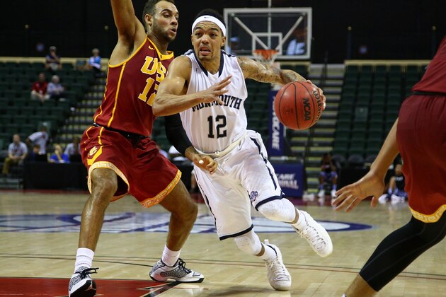 ORLANDO, FL - NOVEMBER 29: Justin Robinson #12 of the Monmouth Hawks drives against Julian Jacobs #12 of the USC Trojans during the game at HP Field House on November 29, 2015 in Orlando, Florida.  (Photo by Rob Foldy/Getty Images)