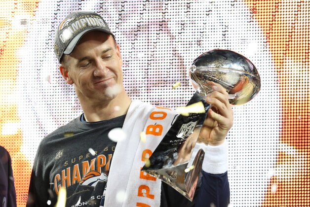Feb 7, 2016; Santa Clara, CA, USA; Denver Broncos quarterback Peyton Manning (18) looks at the Vince Lombardi Trophy after beating the Carolina Panthers in Super Bowl 50 at Levi's Stadium. Mandatory Credit: Matthew Emmons-USA TODAY Sports