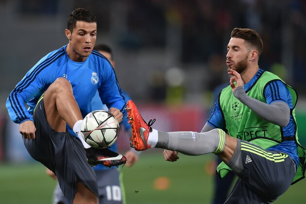 Real Madrid's Portuguese forward Cristiano Ronaldo (L) and Real Madrid's defender Sergio Ramos warm up before the UEFA Champions League football match AS Roma vs Real Madrid on Frebruary 17, 2016 at the Olympic stadium in Rome.  AFP PHOTO / ALBERTO PIZZOLI / AFP / ALBERTO PIZZOLI        (Photo credit should read ALBERTO PIZZOLI/AFP/Getty Images)