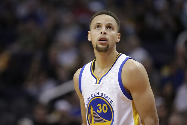 Golden State Warriors' Stephen Curry looks at the clock during the second half of an NBA basketball game against the Phoenix Suns, Wednesday, Feb. 10, 2016, in Phoenix. (AP Photo/Matt York)