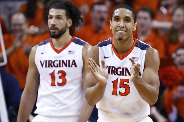 Virginia guard Malcolm Brogdon (15) and forward Anthony Gill (13) celebrate a play during the second half of an NCAA college basketball game against North Carolina in Charlottesville, Va., Saturday, Feb. 27, 2016. Virginia won 79-74. (AP Photo/Steve Helber)