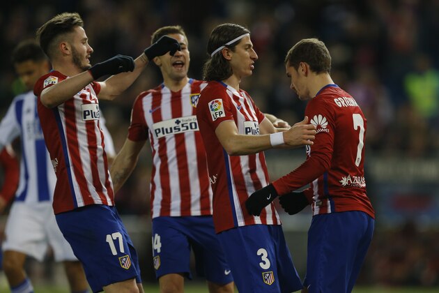 Atletico Madrid's Antoine Griezmann, right, is congratulated by teammates after scoring against Real Sociedad their side's third goal during a Spanish La Liga soccer match between Atletico Madrid and Real Sociedad at the Vicente Calderon stadium in Madrid, Tuesday, March 1, 2016. (AP Photo/Francisco Seco)
