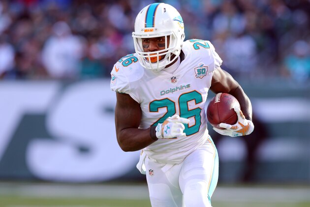 Miami Dolphins running back Lamar Miller (26) runs with the ball against the New York Jets during an NFL game at MetLife Stadium in East Rutherford, N.J. on Sunday, Nov. 29, 2015. (AP Photo/Brad Penner)