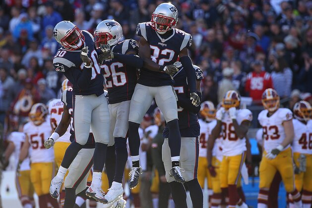 FOXBORO, MA - NOVEMBER 8: Duron Harmon #30, Logan Ryan #26, and Devin McCourty #32 of the New England Patriots celebrate an interception in the first half against the Washington Redskins at Gillette Stadium on November 8, 2015 in Foxboro, Massachusetts. (Photo by Jim Rogash/Getty Images)