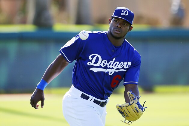 Los Angeles Dodgers' Yasiel Puig reaches out to make a catch on a baseball during outfield drills during a spring training baseball workout Friday, Feb. 26, 2016, in Glendale, Ariz. (AP Photo/Ross D. Franklin)