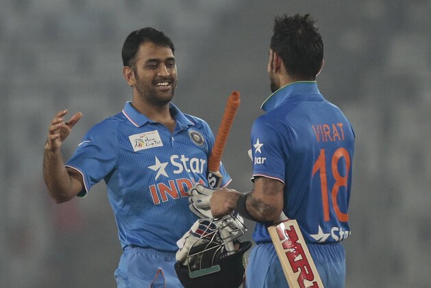 India’s captain Mahendra Dhoni, left, celebrates with his teammate Virat Kohli  after winning the Asia Cup Twenty20 international cricket match against Sri Lanka in Dhaka, Bangladesh, Tuesday, March 1, 2016. (AP Photo/A.M. Ahad)