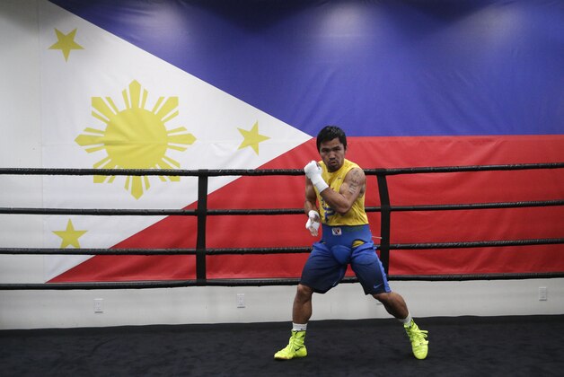 Boxer Manny Pacquiao, of the Philippines, works out near a Philippines flag at Wild Card Boxing Club, Monday, April 27, 2015, in Los Angeles. Pacquiao is scheduled to fight Floyd Mayweather Jr. in a welterweight boxing match in Las Vegas on Saturday. (AP Photo/Jae C. Hong)