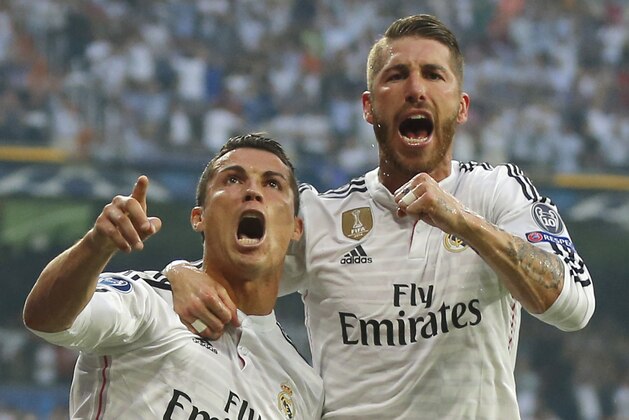 Real Madrid's Sergio Ramos, right, celebrates with Real Madrid's Cristiano Ronaldo who scored 1-0 during the Champions League second leg semifinal soccer match between Real Madrid and Juventus, at the Santiago Bernabeu stadium in Madrid, Wednesday, May 13, 2015. (AP Photo/Daniel Ochoa de Olza)
