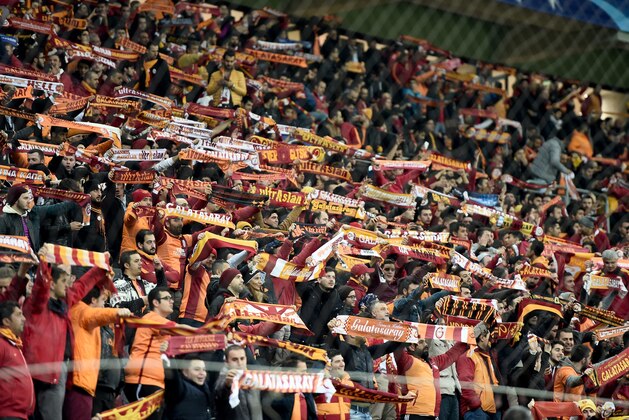 Galatasaray's supporters hold scarves   during the UEFA Champions League Group C football match between Galatasaray AS and FC Astana at the Turk Telekom Arena in Istanbul on December 8, 2015.  / AFP / OZAN KOSE        (Photo credit should read OZAN KOSE/AFP/Getty Images)