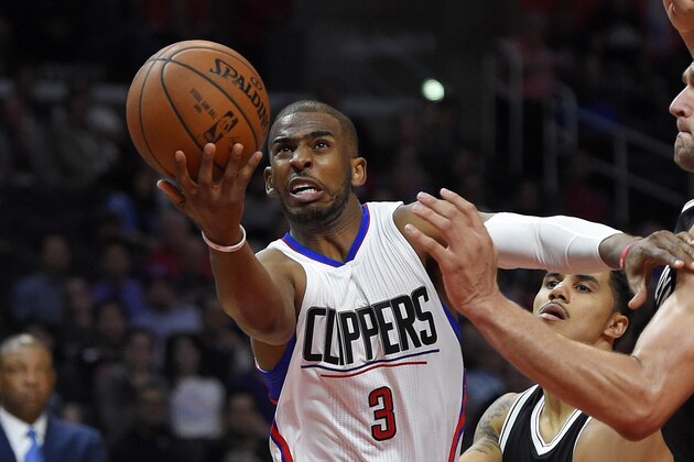 Los Angeles Clippers guard Chris Paul, left, shoots as Brooklyn Nets guard Shane Larkin, center, and center Brook Lopez defend during the second half of an NBA basketball game, Monday, Feb. 29, 2016, in Los Angeles. The Clippers won 105-95. (AP Photo/Mark J. Terrill)