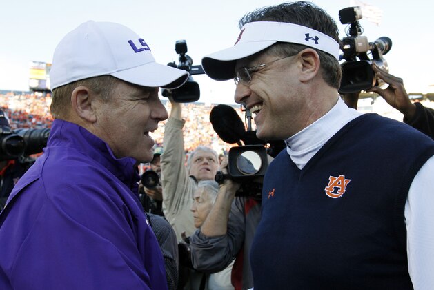 LSU head coach Les Miles, left, and Auburn head coach  Gus Malzahn shakes hands at midfield before their NCAA college football game, Saturday, Oct. 4, 2014, in Auburn, Ala. (AP Photo/Butch Dill)