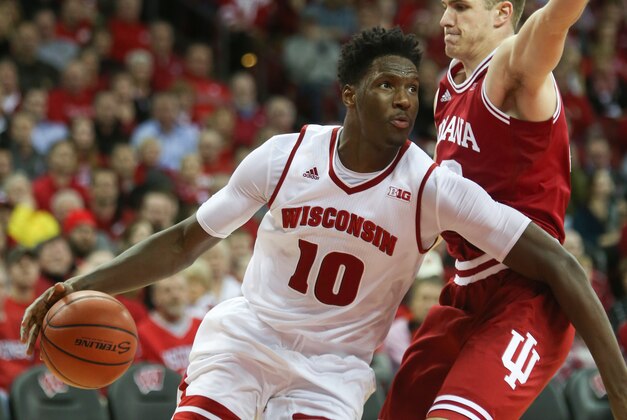 Jan 26, 2016; Madison, WI, USA; Wisconsin Badgers forward Nigel Hayes (10) drives to the basket as Indiana Hoosiers forward Collin Hartman (right) defends  at the Kohl Center. Wisconsin defeated Indiana 82-79 (OT). Mandatory Credit: Mary Langenfeld-USA TODAY Sports