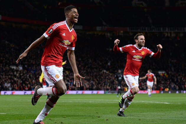 Manchester United's English striker Marcus Rashford (L) celebrates scoring his team's third goal with Manchester United's Spanish midfielder Juan Mata during the UEFA Europa League round of 32, second leg football match between Manchester United and and FC Midtjylland at Old Trafford in Manchester, north west England, on February 25, 2016.  / AFP / OLI SCARFF        (Photo credit should read OLI SCARFF/AFP/Getty Images)