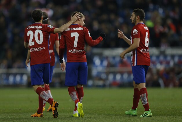 Atletico Madrid's Antoine Griezmann, center, is congratulated by teammates Juan Francisco Torres “Juanfran”, left, and Jorge Resurreción “Koke” after scoring against Real Sociedad their side's third goal during a Spanish La Liga soccer match between Atletico Madrid and Real Sociedad at the Vicente Calderon stadium in Madrid, Tuesday, March 1, 2016. Griezmann scored once in Atletico's 3-0 victory. (AP Photo/Francisco Seco)