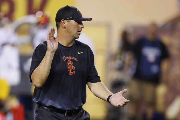 Southern California head coach Steve Sarkisian applauds his players as they warm up prior to an NCAA college football game against Arizona State Saturday, Sept. 26, 2015, in Tempe, Ariz. (AP Photo/Ross D. Franklin)