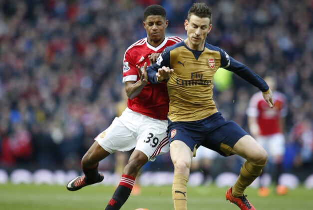 Manchester United's Marcus Rashford, left vies for the ball with Arsenal's Laurent Koscielny during the English Premier League soccer match between Manchester United and Arsenal at Old Trafford Stadium, Manchester, England, Sunday, Feb. 28, 2016. (AP Photo/Jon Super)