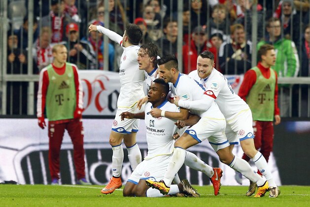 Mainz’s Jhon Cordoba, bottom, celebrates with teammates after scoring his side's second goal during the German Bundesliga soccer match between FC Bayern Munich and FSV Mainz 05 at the Allianz Arena stadium in Munich, Germany, Wednesday, March 2, 2016. (AP Photo/Matthias Schrader)