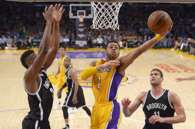 Los Angeles Lakers guard D'Angelo Russell shoots as Brooklyn Nets forward Thaddeus Young, left, and center Brook Lopez defend during the second half of an NBA basketball game Tuesday, March 1, 2016, in Los Angeles. The Lakers won 107-101. (AP Photo/Mark J. Terrill)