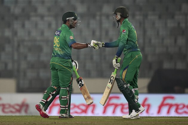 Pakistan’s Umar Akmal, left, and Shoaib Malik cheer each other during the Asia Cup Twenty20 international cricket match against United Arab Emirates in Dhaka, Bangladesh, Monday, Feb. 29, 2016. (AP Photo/A.M. Ahad)