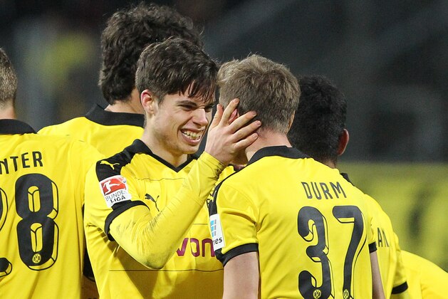 Dortmund's defender Erik Durm (R) celebrates scoring the 2-0 with his team-mates  during the German first division Bundesliga football match  SV Darmstadt 98 v BVB Borussia Dortmund in Darmstadt, western Germany on March 2, 2016. / AFP / DANIEL ROLAND / RESTRICTIONS: DURING MATCH TIME: DFL RULES TO LIMIT THE ONLINE USAGE TO 15 PICTURES PER MATCH AND FORBID IMAGE SEQUENCES TO SIMULATE VIDEO. == RESTRICTED TO EDITORIAL USE == FOR FURTHER QUERIES PLEASE CONTACT DFL DIRECTLY AT + 49 69 650050
        (Photo credit should read DANIEL ROLAND/AFP/Getty Images)