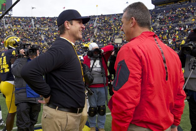 FILE - In this Nov. 28, 2015, file photo, Michigan coach Jim Harbaugh, left, greets Ohio State coach Urban Meyer before an NCAA college football game in Ann Arbor, Mich. When it comes to recruiting in the Big Ten, Meyer and Harbaugh are the heavyweights. For most of the other teams, one of the most important selling points is saying true to the school’s identity and selling the right “fit. FILE - In this Nov. 28, 2015, file photo, Michigan coach Jim Harbaugh, left, greets Ohio State coach Urban Meyer before an NCAA college football game in Ann Arbor, Mich. When it comes to recruiting in the Big Ten, Meyer and Harbaugh are the heavyweights. For most of the other teams, one of the most important selling points is saying true to the school’s identity and selling the right “fit.