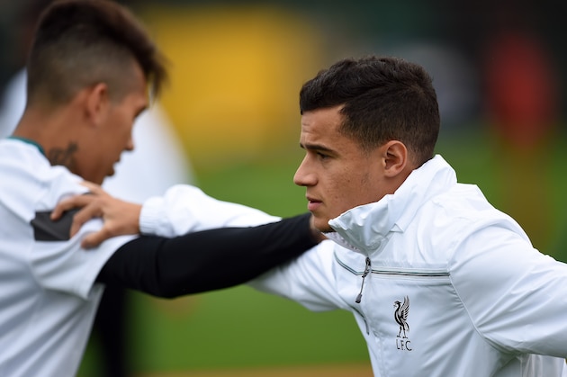 Liverpool's Brazilian midfielder Philippe Coutinho (R) stretches with Brazilian midfielder Roberto Firmino during a team training session in Liverpool, northwest England, on October 21, 2015, on the eve of their UEFA Europa League group B football match against Rubin Kazan. AFP PHOTO / PAUL ELLIS        (Photo credit should read PAUL ELLIS/AFP/Getty Images)
