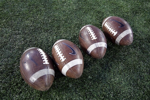 Footballs sit on the field before an NCAA college football game between Memphis and Houston Saturday, Nov. 14, 2015, in Houston. (AP Photo/David J. Phillip)