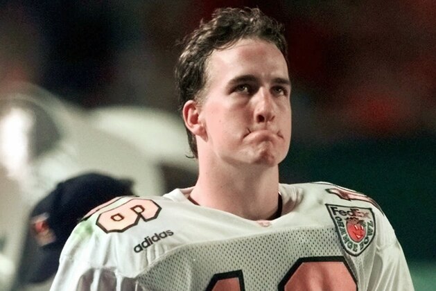 Tennessee quarterback Peyton Manning grimaces on the sideline in the closing moments of their 42-17 loss to Nebraska in the Orange Bowl at Pro Player Stadium in Miami, Fla., Friday, Jan. 2, 1998. (AP Photo/Joe Cavareta)