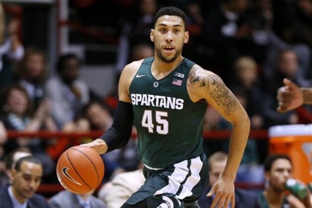 FILE - In this Dec. 19, 2015, file photo, Michigan State's Denzel Valentine brings the ball upcourt during the first half of an NCAA college basketball game against Northeastern in Boston. Valentine will be out for two to three weeks with a knee injury. Coach Tom Izzo said Monday, Dec. 21, 2015, that Valentine had a piece of cartilage removed after an injury in practice Sunday. (AP Photo/Winslow Townson, File)