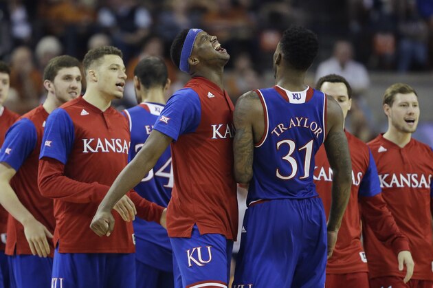 Kansas forward Carlton Bragg Jr., center, celebrates with teammate Kansas forward Jamari Traylor (31) as he walks off the court during the second half of an NCAA college basketball game against Texas, Monday, Feb. 29, 2016, in Austin, Texas. Kansas won 86-56. (AP Photo/Eric Gay)