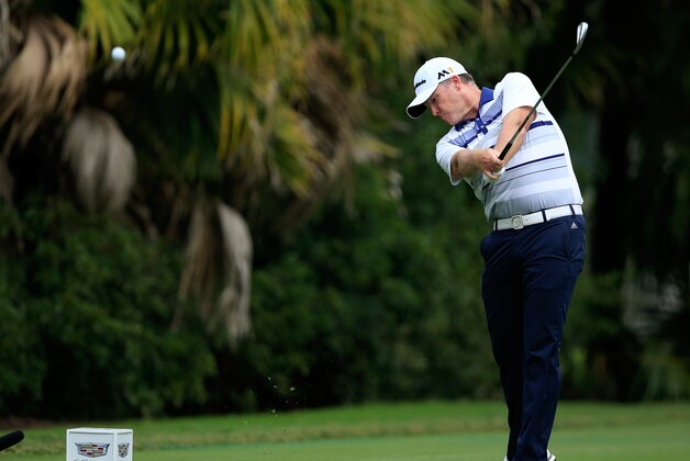DORAL, FL - MARCH 03:  Marcus Fraser of Australia plays his tee shot at the par 3, 13th hole during the first round of the 2016 World Golf Championship Cadillac Championship on the Blue Monster Course at the Trump National Resort on March 3, 2016 in Doral, Florida.  (Photo by David Cannon/Getty Images)