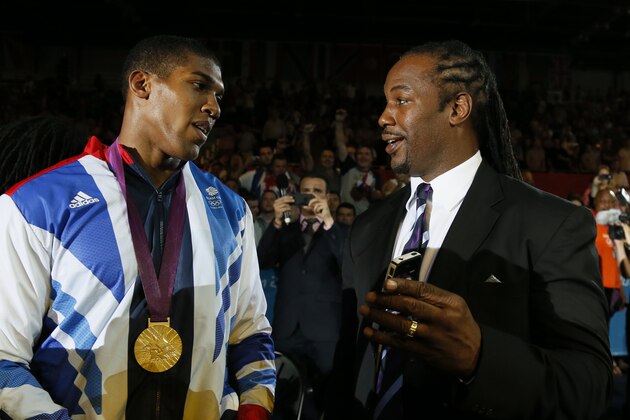 Gold medalist Anthony Joshua (L) celebrates with former world heavweight boxing champion and fellow countryman Lennox Lewis (R) during the awards ceremony for the Super-Heavyweight (+91kg) boxing category of the 2012 London Olympic Games at the ExCel Arena August 12, 2012 in London. AFP PHOTO / Jack GUEZ        (Photo credit should read JACK GUEZ/AFP/GettyImages)