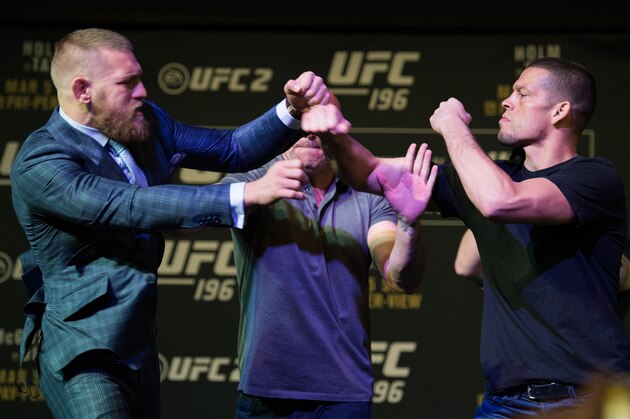 LAS VEGAS, NV - MARCH 3:   (L-R) UFC featherweight champion Conor McGregor throws a punch towards Nate Diaz during the UFC 196 Press Conference at David Copperfield Theater in the MGM Grand Hotel/Casino on March 3, 2016 in Las Vegas, Nevada. (Photo by Brandon Magnus/Zuffa LLC/Zuffa LLC via Getty Images)